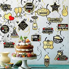 a cake sitting on top of a table in front of a wall covered with signs