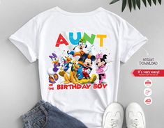 the birthday boy shirt with mickey mouse and friends on it is next to a pair of sneakers