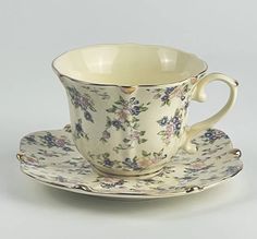 a cup and saucer with flowers on it