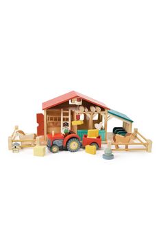 a wooden toy farm with tractor, barn and horse on the white background for text