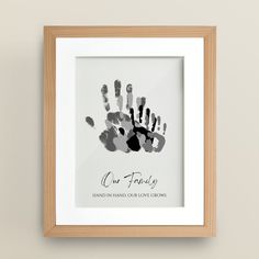 a hand print with the words our family in black and grey ink on a white background