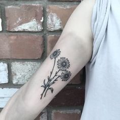 a person with a tattoo on their arm has a flower in the middle of his arm