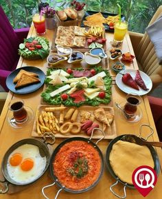 a long table filled with different types of food and drinks on it's sides