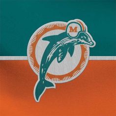 the miami dolphins logo on an orange, green and white jersey with a dolphin's head