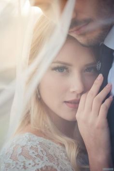 a man and woman standing next to each other with their hands on their foreheads