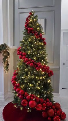 a christmas tree with red ornaments and lights