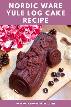 a chocolate log cake on a cutting board with pine cones in the background and text overlay that reads nordic ware yule log cake recipe