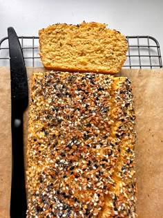 a loaf of bread sitting on top of a cutting board next to a knife