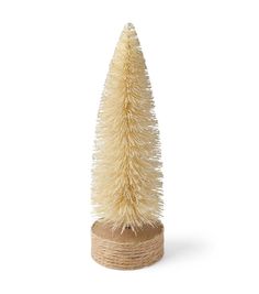 a small white christmas tree sitting on top of a wooden stand