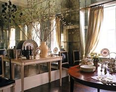 a dining room filled with furniture and mirrors