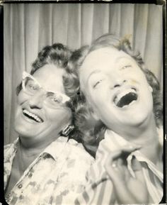 an old black and white photo of two women with their mouths open, one is laughing