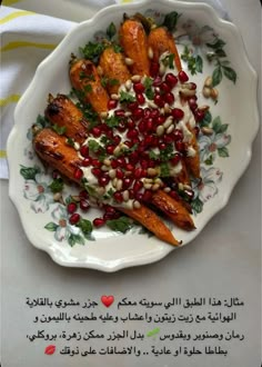 a white plate topped with sweet potatoes covered in pomegranate and garnish