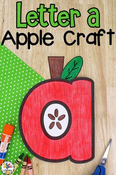 an apple craft with scissors and crayons next to it