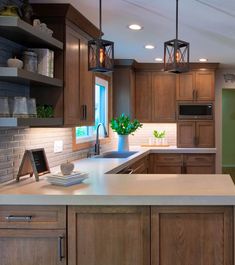 a kitchen with wooden cabinets and white counter tops, along with an island in the middle