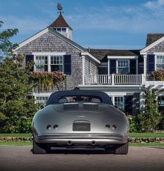 a silver sports car parked in front of a house