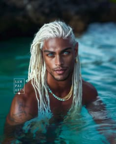 a man with long blonde hair and piercings swimming in the water wearing a pearl necklace