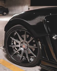 a black sports car parked in a parking lot