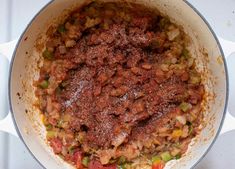 a pot filled with food sitting on top of a stove