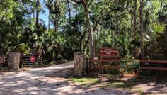 the entrance to an area that is surrounded by trees