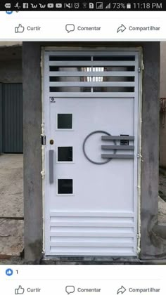 a white door with metal bars on the top and bottom, in front of a building