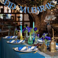 a table set with blue and white plates