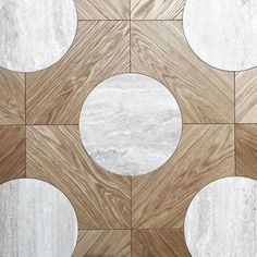 a tile floor with white and brown circles on it's sides, as well as the center