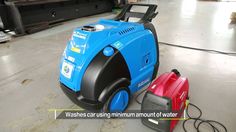 a blue and black vacuum sitting on top of a floor next to a red machine