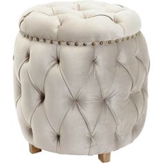 a white ottoman with gold studding on it