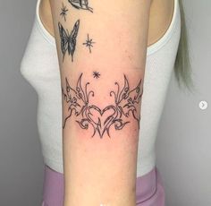 a woman's arm with tattoos on it and butterflies in the middle of her arm