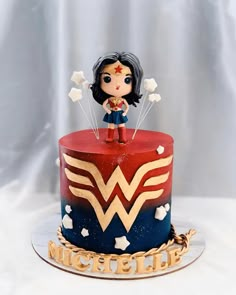 a cake with a wonder woman figure on top