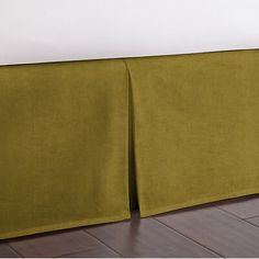 a bed with a green headboard on top of it