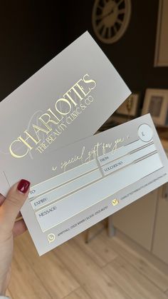 a person holding up a business card that says charlotte's international hotel company on it