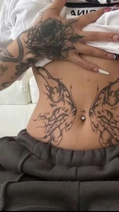 a woman with tattoos on her stomach