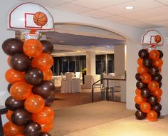 an indoor basketball court decorated with balloons