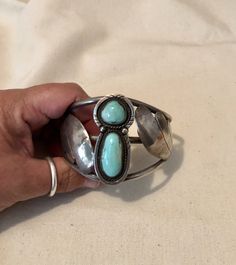 "Large Vintage Native American Indian Sterling Silver And Bright Blue Turquoise Unisex Cuff Bracelet With Two Stones $595.00 A collectable statement piece for the larger wrist. This vintage Native American sterling silver and bright blue turquoise cuff measures approximately 2 3/4\" across on the inside and 2 1/8\" from front to back inside. The total weight is 62.5 grams. The base of the cuff is quite traditional with three strips of half round wire soldered together side by side at the ends an Adjustable Turquoise Bangle For Collectors, Artisan Blue Cuff Bangle Bracelet, Artisan Blue Bangle Cuff Bracelet, Unique Blue Bangle Cuff Bracelet, Vintage Turquoise Oyster Bracelet, Elegant Turquoise Bracelets With Patina, Elegant Turquoise Bracelet With Patina, Southwestern Blue Cuff Jewelry, Vintage Turquoise Bangle Cuff Bracelet