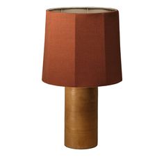 an orange lamp with a brown shade on it's base and a white background