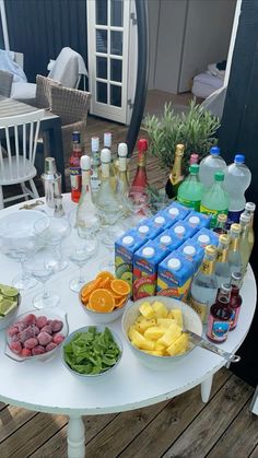 the table is full of drinks and snacks on it's own patio deck,