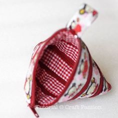 a small red and white bag sitting on top of a table