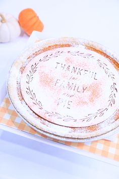 a pie sitting on top of a table next to a plate with the words thank you