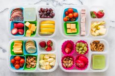 four plastic containers filled with different types of food on a marble counter top next to grapes, strawberries, bananas and other fruits