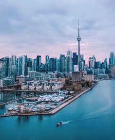 an aerial view of the city skyline and harbor in toronto, canada with boats on the water