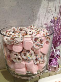 a glass bowl filled with marshmallows and sprinkles