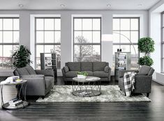 a living room filled with furniture and large windows