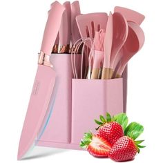 pink utensils and strawberries in a holder