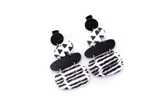 These black and white earrings are a super fun accessory to top off an outfit. Each earring features solid black acrylic charms paired with black and white triangle print and chevron charms. They are the perfect mix of patterns that is far from boring! The earrings are finished off with stainless steel ear posts. MATERIALS Acrylic Stainless Ear Posts LENGTH 2 1/4" CARE Direct contact with perfumes and moisture should be avoided to minimize damage or discoloration. Please remove before showering, Trendy Black Geometric Earrings, Bold Black Drop Earrings, Trendy Black Geometric Jewelry, Black And White Earrings, Black Earrings Dangle, Triangle Print, Acrylic Charms, Black Acrylic, White Jewelry