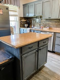 a large kitchen with an island in the middle