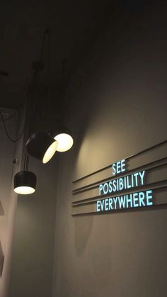 there is a sign on the wall that says see possibility everywhere in blue