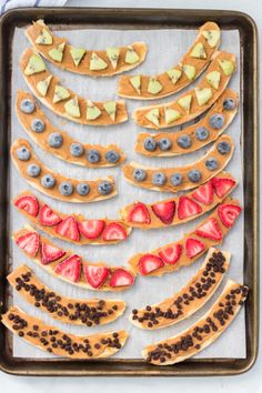 a pan filled with cookies and fruit on top of a baking sheet