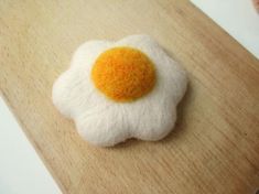 an egg is sitting on top of a piece of felt that looks like it has been fried