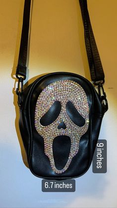 Ghost face cross body bag in pleather material. 6.7 inches across and around 9 inches top to bottom. AB glass crystal rhinestones. Ghost Face Mask, Concert Bags, Gothic Bag, Halloween 3, Hamsa Bracelet, Cat Keychain, Ghost Face, Halloween Bags, Sling Bags